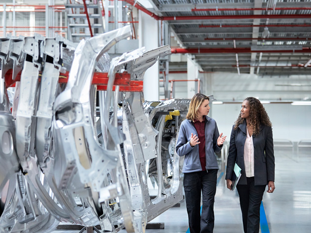 View two women in automotive factory