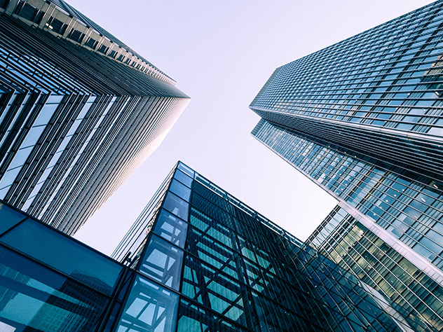 bâtiments modernes dans de grandes villes, reflet d'un immeuble de bureaux illuminé dans un bureau de verre